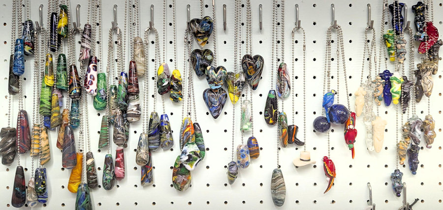 Ceiling fan pulls, inventory hanging on pegboard display, cylinders, twists, flat spoon shapes, balls, bodies, hearts